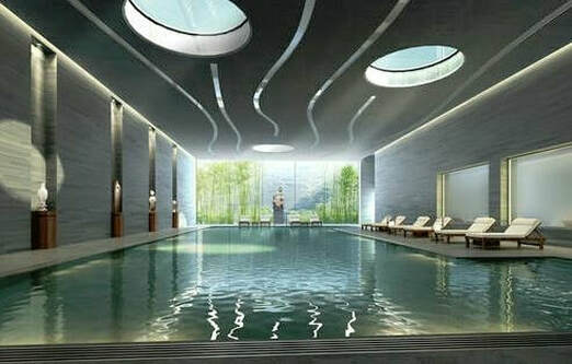 Picture of an indoor spotless green shimmering indoor pool with gorgeous surroundings